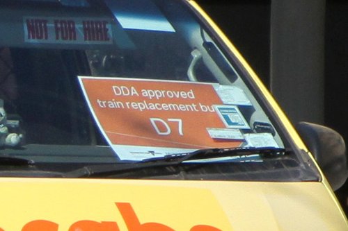 'DDA approved train replacement bus' sign in the front of a 13CABS maxi taxi