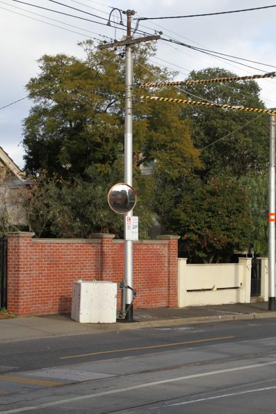 Damaged steel post reinforced with a concrete block at the base outside Kew Depot