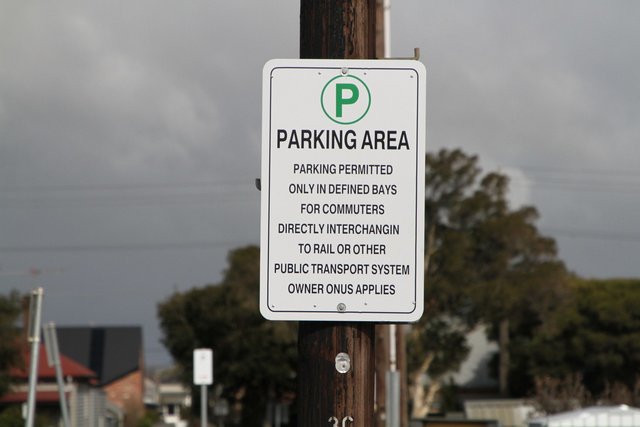 'Parking permitted only in defined bays for commuters directly interchanging to rail or other public transport system' sign in the car park