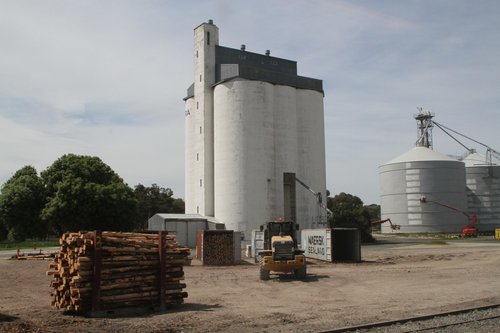 Specially fitted loader pushes the logs into a 40 footer container