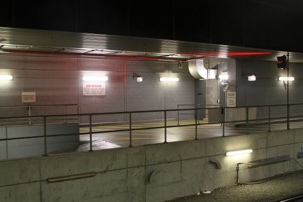 'Push button to activate green light' protects access along the single lane road to the northern vehicle subway