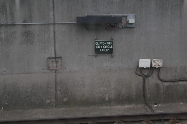 Glow in the dark 'Clifton Hill / City Circle Loop' signage at the Southern Cross portal