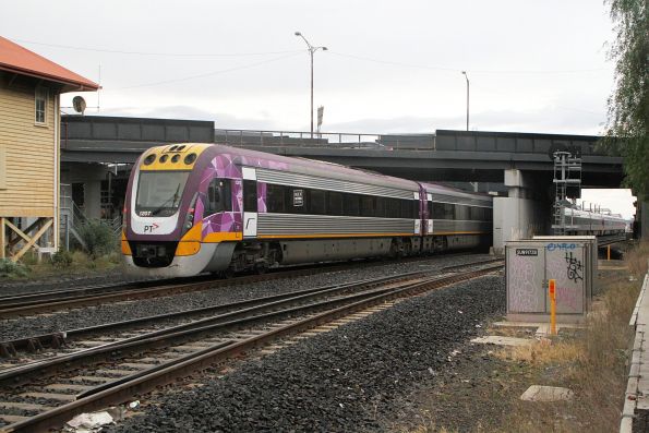 The last one and a 1/2 carriages of the 9-car test train overhang platform 3 at Sunshine