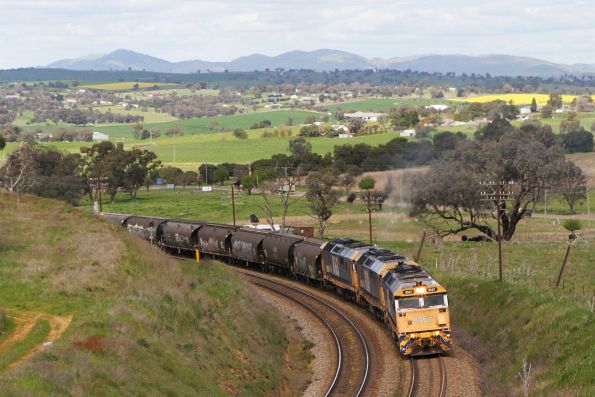 8167, 8130 and 8163 lead a southbound loaded grain slowly up the grade into Demondrille 