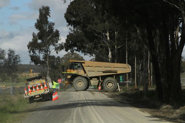 Haul truck crosses the access road to Marulan South, after dumping overburden from the Peppertree Quarry