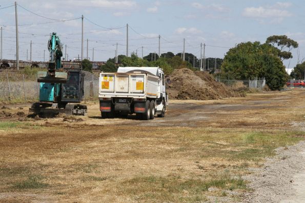 Digging up the grass along Rupert Street near Tottenham station for a temporary gravel car park for those being closed at Albion and Sunshine station for Melbourne Airport Rail works