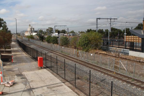 Fencing back in place beside the standard gauge line at Sunshine following service relocation works