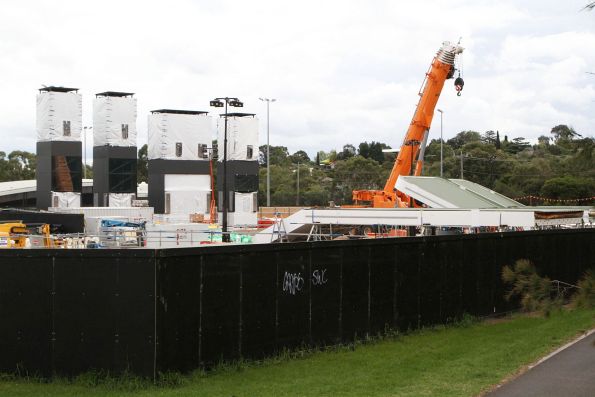 Four prefabricated lift shafts alongside station roof modules awaiting delivery at Elgar Park, Mont Albert North