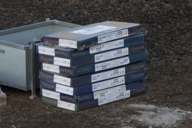 Boxes of Marquee brand 'Steel Park Benches' from Bunnings waiting to be installed around the station