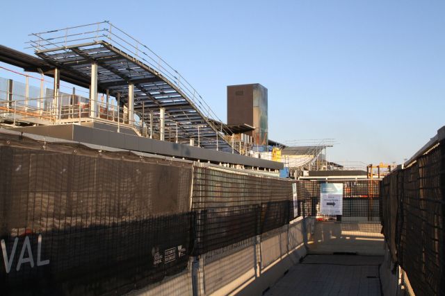 Incomplete stairs and lift to platform 1 beside the temporary platform 2 walkway through the construction site