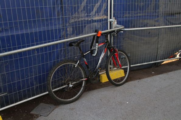 Bike locked up to a random fence at the new Deer Park station