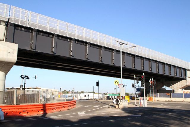 Pair of single track steel truss spans carry trains over Mt Derrimut Road 