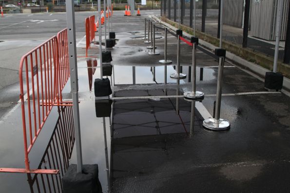 Giant puddle in the middle of the marquee set up at Sunshine station in the Sun Crescent car park for waiting rail replacement bus passengers