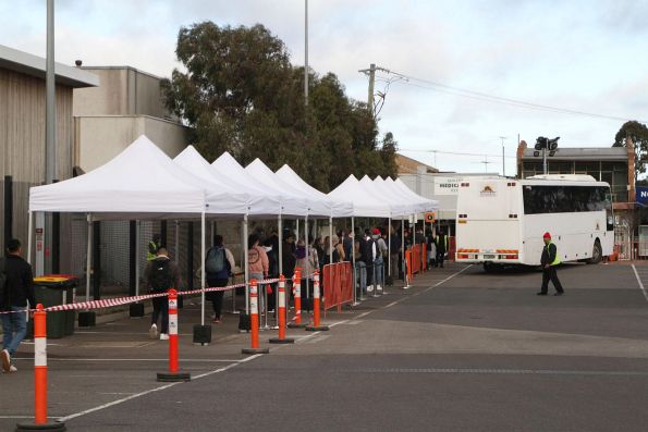 A bus finally shows up but quickly fills, leaving a long line of intending passengers