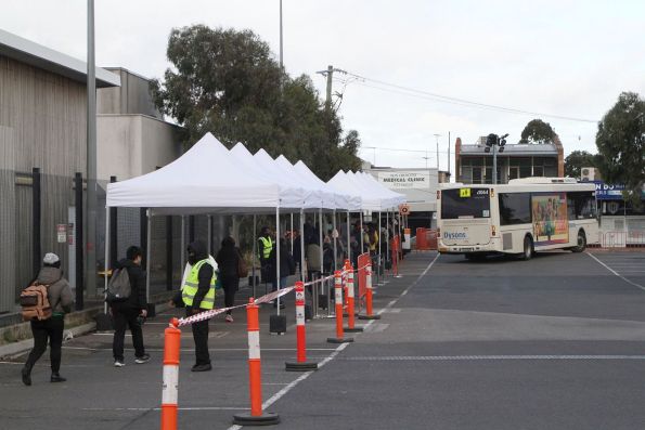 Dysons bus #1064 BS04BJ departs Sunshine, and a queue of intending passengers is already starting to grow again