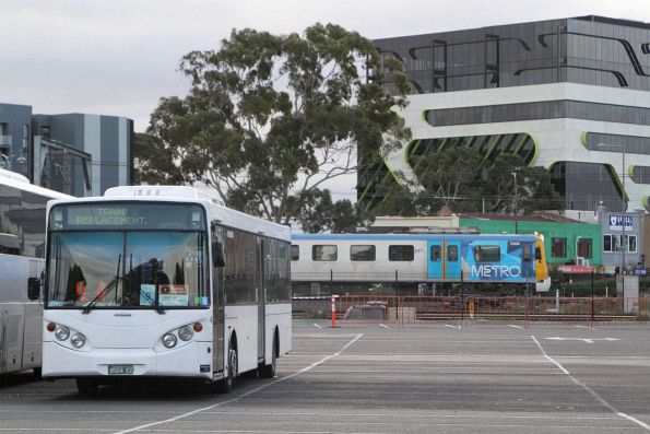 Siemens 784M passes Mee's bus #46 BS04EZ between Sunbury rail replacement services at Sunshine station