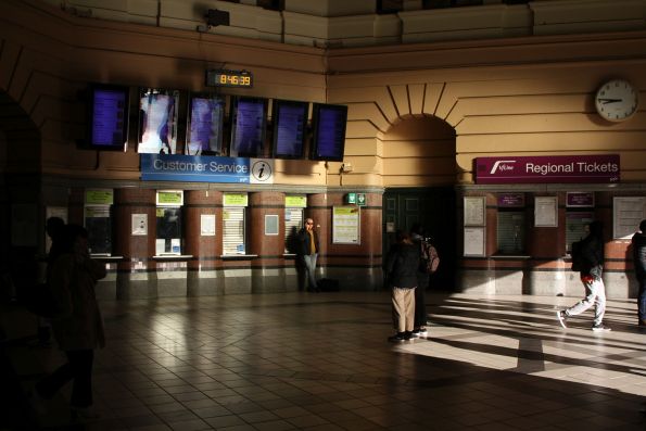 Morning sun streams over the booking offices at Flinders Street Station