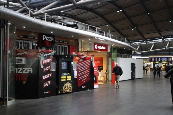 Hot pizza vending machine installed in front of an abandoned health food shop at Southern Cross Station