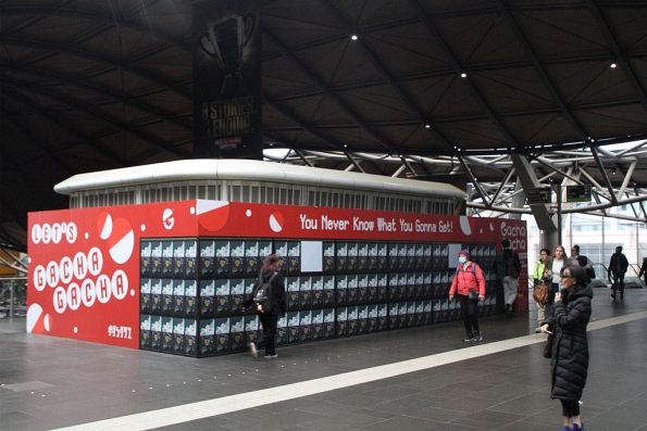 Billboard advertising 'Gacha Gacha' vending machines at Southern Cross Station