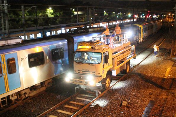 Metro Trains scissor lift hi-rail truck passes the disabled Siemens train