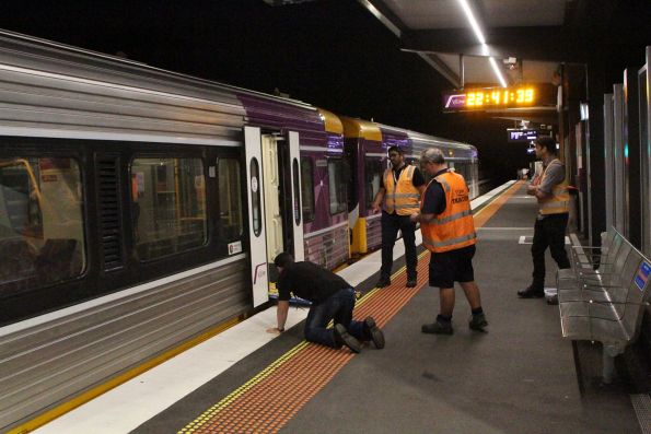 Engineers check the clearances between the modified plug doors fitted to Sprinter 7014 and a wheelchair ramp on the raised platform at Deer Park