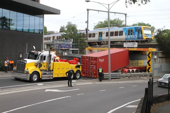 X'Trapolis 199M passes a 40 foot container stuck under the Napier Street bridge, heavy tow truck ready to drag off the truck