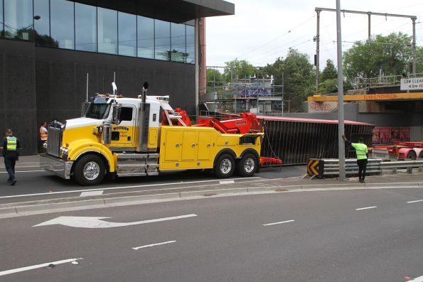 And over it goes - 40 foot container falls onto it's side after being dragged off the truck