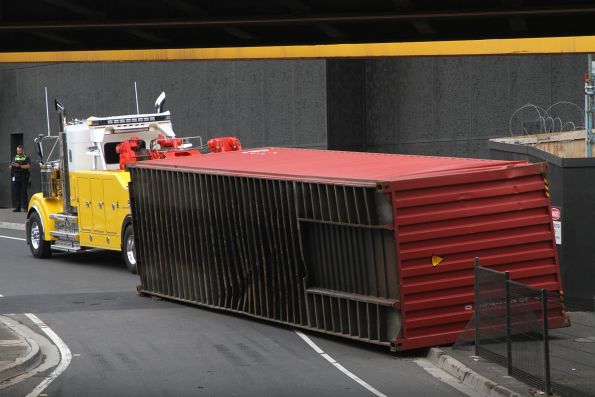 40 foot container sitting on it's side after being dragged off the truck