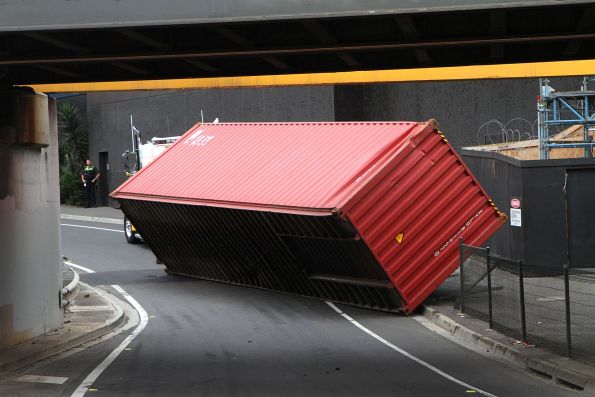 Heavy tow truck pulls the 40 foot container back upright