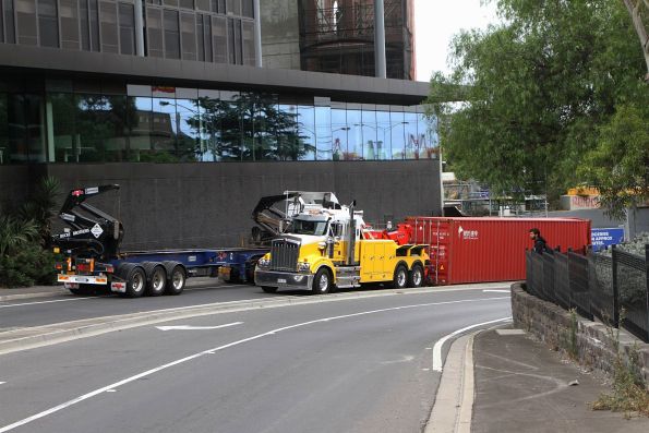 Sidelifter truck ready to pick up the damaged 40 foot container