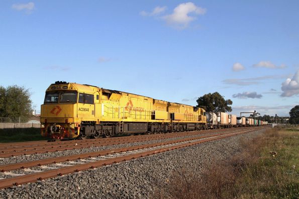 ACD6048 leads 6029 towards McIntyre Loop on a northbound Aurizon intermodal