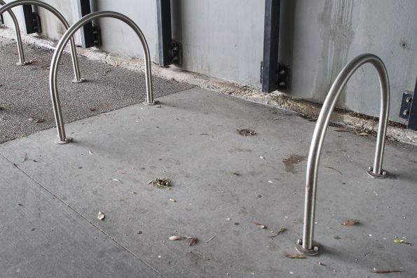 Exposed bolts mark where someone unbolted a bike hoop at Sunshine station to steal the bike locked onto it