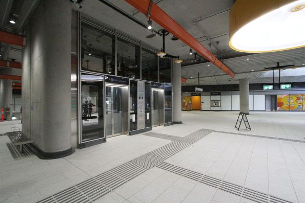 Pair of lifts and escalators down to the north end of the platforms at Anzac station