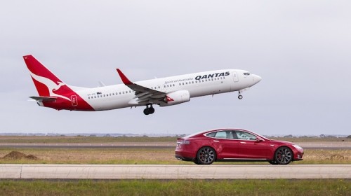 Qantas 737 VH-XZI takes on a Tesla Model S electric car at Avalon. (Qantas)